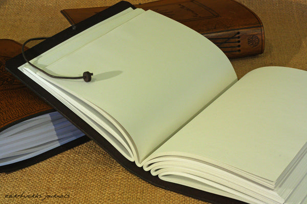 A5 brown leather journal with wild grass design open - earthworks journals