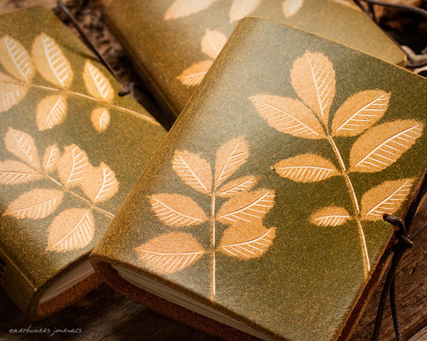 small leather journal with ash leaf design