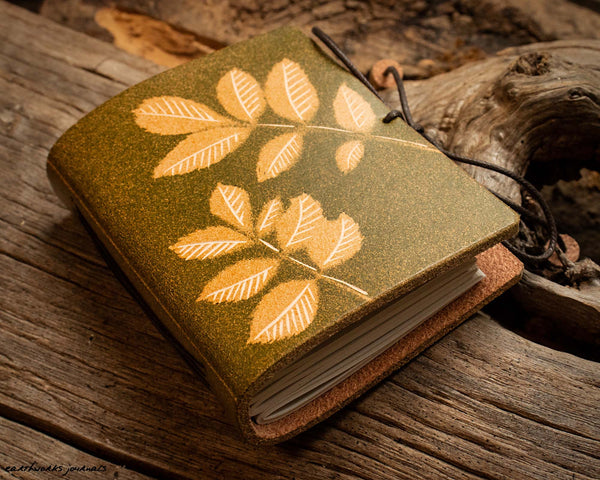 small leather journal with ash leaf design