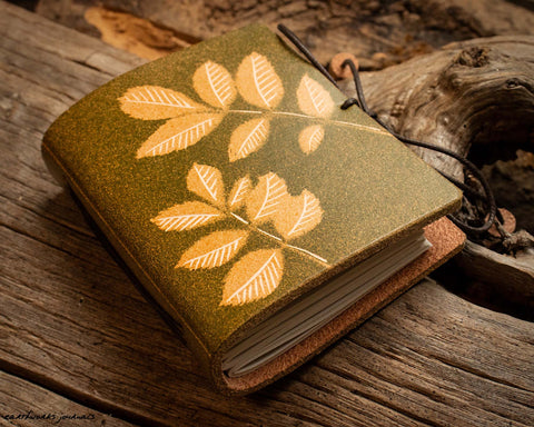 small leather journal with ash leaf design