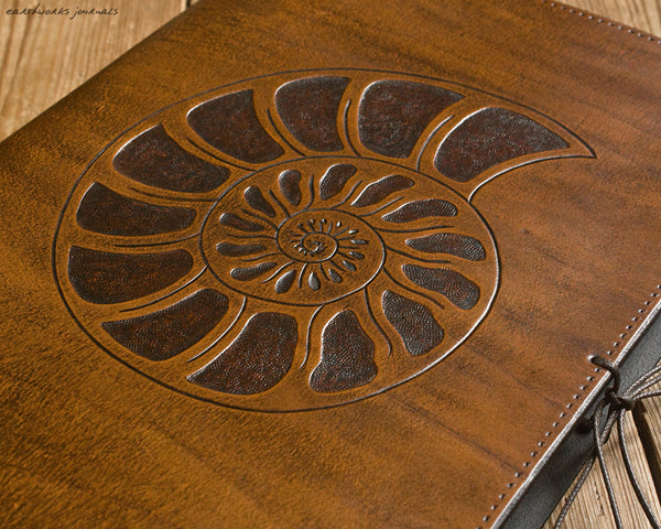 A4 brown leather journal - spiral ammonite design detail - earthworks journals A4C012