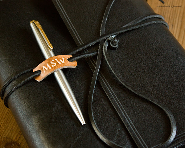 Personalised leather tag and pen loop on black leather wrap journal - earthworks journals
